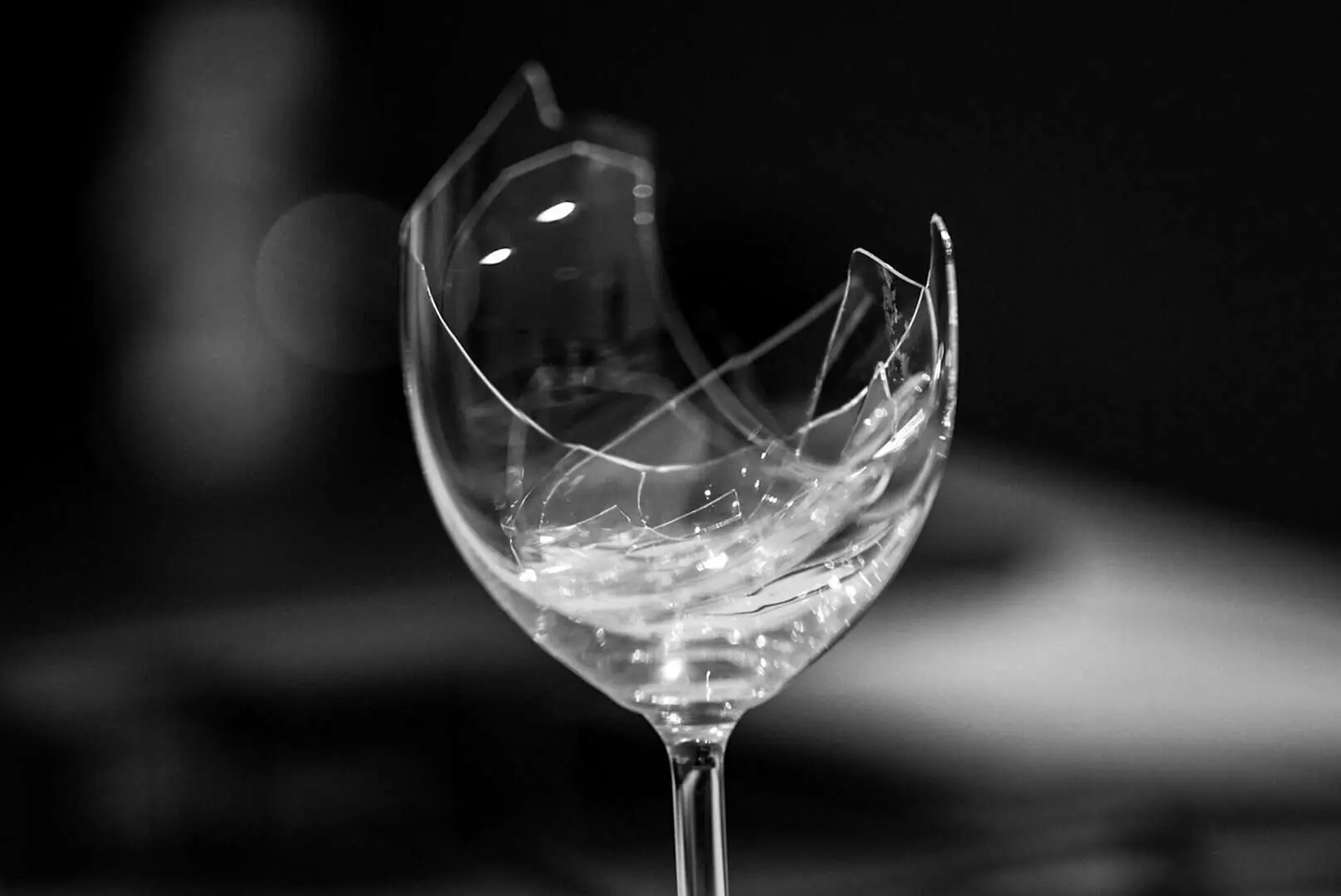 A shattered crystal wine glass, illustrating the risk of damage when glasses are not packed correctly during a house move.