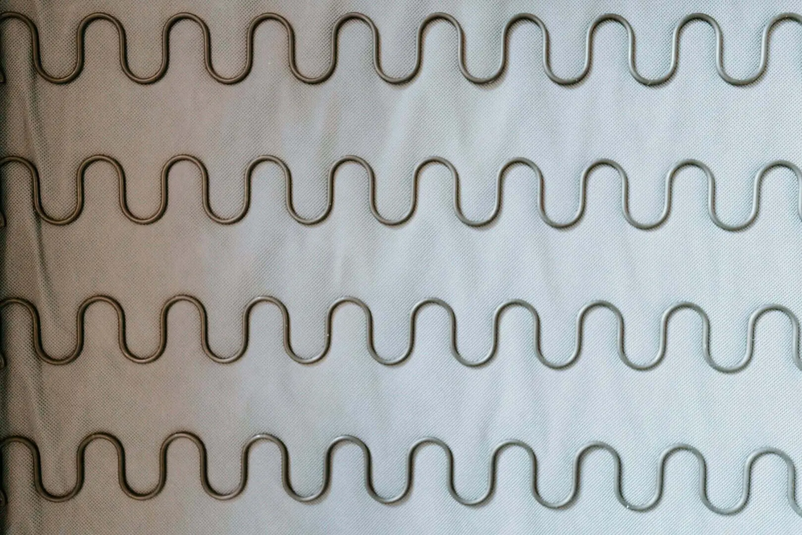 close-up view of the metal spring network inside a non-rollable mattress, highlighting the rigid construction that cannot be rolled for a house move